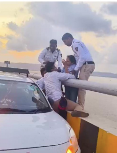 Woman loses balance while sitting on Atal Setu safety barrier, saved by alert cop